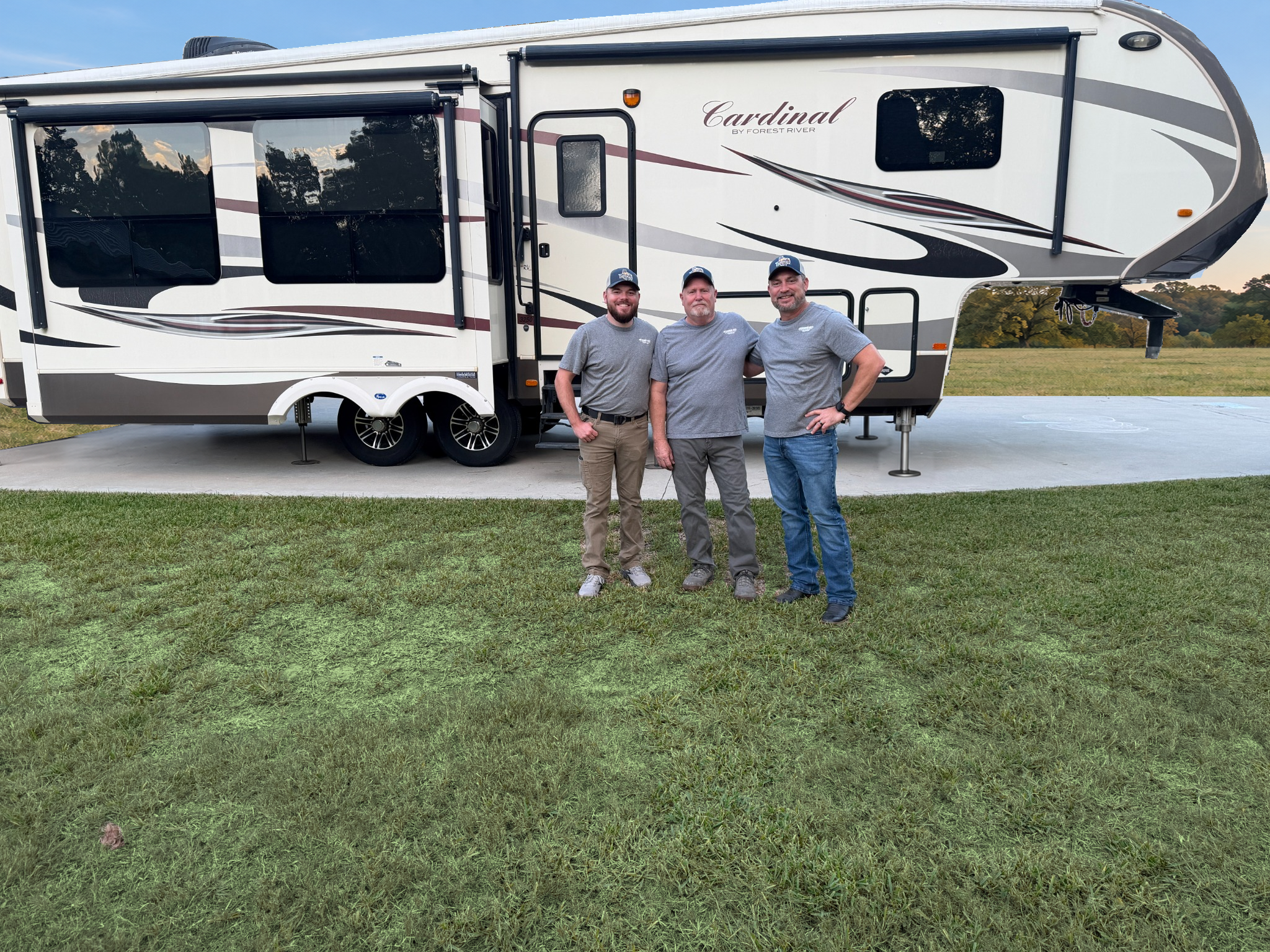 The Southern Sky team standing beside a fifth-wheel RV